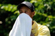 PONTE VEDRA BEACH, FL - MAY 08: Tiger Woods dries his face before playing his tee shot on the fifth hole during the second round of THE PLAYERS Championship on THE PLAYERS Stadium Course at TPC Sawgrass on May 8, 2009 in Ponte Vedra Beach, Florida. (Photo by Sam Greenwood/Getty Images)