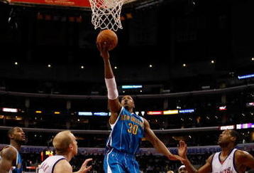 LOS ANGELES, CA - NOVEMBER 09:  David West #30 of the New Orleans Hornets drives to the basket past Chris Kaman (L) #35 and Marcus Camby (R) #23 of the Los Angeles Clippers in the second half at Staples Center on November 9, 2009 in Los Angeles, California. The Hornets defeated the Clippers 112-84.  NOTE TO USER: User expressly acknowledges and agrees that, by downloading and/or using this Photograph, user is consenting to the terms and conditions of the Getty Images License Agreement.  (Photo by Jeff Gross/Getty Images)