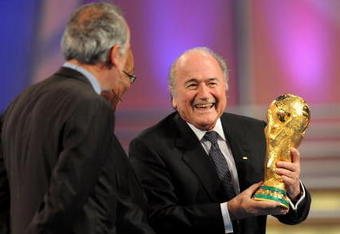 CAPE TOWN, SOUTH AFRICA - DECEMBER 04:  FIFA President Sepp Blatter (R) holds the World Cup next to South African President Jacob Zuma (C) during the Final Draw for the FIFA World Cup 2010 December 4, 2009 at the International Convention Centre in Cape Town, South Africa.  (Photo by Shaun Botterill/Getty Images)