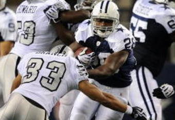 ARLINGTON, TX - NOVEMBER 26:  Running back Felix Jones #28 of the Dallas Cowboys runs the ball against Tyvon Branch #33 of the Oakland Raiders at Cowboys Stadium on November 26, 2009 in Arlington, Texas.  (Photo by Ronald Martinez/Getty Images)