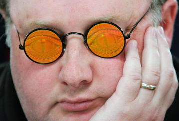 LAS VEGAS - JULY 30:  Poker player Greg 'Fossilman' Raymer, the 2004 World Series of Poker champion, wears his holographic glasses as he competes on the third day of the first round of the WSOP no-limit Texas Hold 'em main event at the Rio Hotel & Casino July 30, 2006 in Las Vegas, Nevada. More than 8,600 players have registered to play in the main event. The final nine players will compete for the top prize of more than USD 11.7 million on the final table which begins August 10.  (Photo by Ethan Miller/Getty Images)