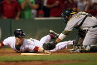 BOSTON - JULY 28:  Jason Bay #44 of the Boston Red Sox is tagged out by catcher Kurt Suzuki #8 of the Oakland Athletics in the eighth inning at Fenway Park July 28, 2009 in Boston, Massachusetts.  (Photo by Elsa/Getty Images)