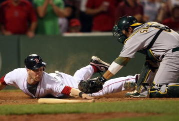 BOSTON - JULY 28:  Jason Bay #44 of the Boston Red Sox is tagged out by catcher Kurt Suzuki #8 of the Oakland Athletics in the eighth inning at Fenway Park July 28, 2009 in Boston, Massachusetts.  (Photo by Elsa/Getty Images)