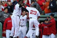 BOSTON - OCTOBER 11:  Joey Gathright #23 of the Boston Red Sox is celebrates with teammate David Ortiz #34 after scoring on a RBI single by Mike Lowell #25 in the eighth inning of Game Three of the ALDS against the Los Angeles Angels of Anaheim during the 2009 MLB Playoffs at Fenway Park on October 11, 2009 in Boston, Massachusetts. (Photo by Elsa/Getty Images)