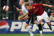 ROME - OCTOBER 31:   Tommaso Rocchi of Lazio competes for the ball with Philippe Mexes of Roma (R) during the Serie A match between Roma and Lazio at the Stadio Olimpico on October 31, 2007 in Rome, Italy.  (Photo by New Press/Getty images)