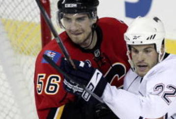 CALGARY, CANADA - SEPTEMBER 15: Matt Pelech #56 of the Calgary Flames battles with Jean-Francois Jacques #22 of the Edmonton Oilers in the third period of the pre-season NHL game on September 15, 2009 at the Pengrowth Saddledome in Calgary, Alberta, Canada. (Photo by Mike Ridewood/Getty Images)