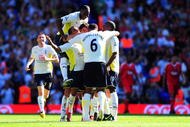 LONDON, ENGLAND - AUGUST 16: Benoit Assou-Ekotto (3rd L) of Tottenham is congratulated by teammates after scoring the opening goal during the Barclays Premier League match between Tottenham Hotspur and Liverpool at White Hart Lane on August 16, 2009 in London, England. (Photo by Mike Hewitt/Getty Images)