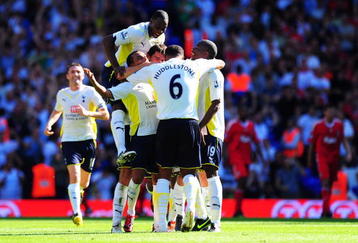 LONDON, ENGLAND - AUGUST 16:  Benoit Assou-Ekotto (3rd L) of Tottenham is congratulated by teammates after scoring the opening goal during the Barclays Premier League match between Tottenham Hotspur and Liverpool at White Hart Lane on August 16, 2009 in London, England.  (Photo by Mike Hewitt/Getty Images)