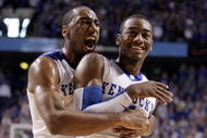LEXINGTON, KY - DECEMBER 05:  John Wall #11 (right) and Ramon Harris #5 of the Kentucky Wildcats celebrate during the game against the North Carolina Tar Heels on December 5, 2009 at Rupp Arena in Lexington, Kentucky. Kentucky won 68-66.  (Photo by Andy Lyons/Getty Images)