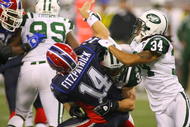 TORONTO - DECEMBER 3: Eric Smith #33 and Marquice Cole #34 of the New York Jets hit quarterback Ryan Fitzpatrick #14 of the Buffalo Bills as he throws the ball at Rogers Centre on December 3, 2009 in Toronto, Canada.  (Photo by Rick Stewart/Getty Images)
