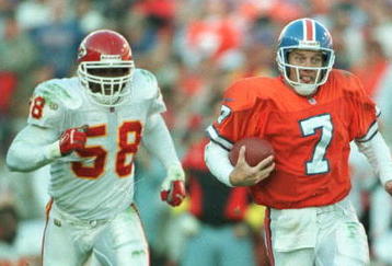 27 Oct 1996:  Quarterback John Elway of the Denver Broncos runs away from Derrick Thomas of the Kansas City Chiefs during the second half of the Broncos v Chiefs game at Mile High Stadium in Denver, Colorado. The Broncos won 34-7. Mandatory Credit: Jed Ja