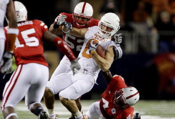 ARLINGTON, TX - DECEMBER 5:  Jordan Shipley #8 of the Texas Longhorns is stopped by Phillip Dillard #52 and Larry Asante #4 of the Nebraska Cornhuskers for a 15-yard penalty in the final minutes of the game at Cowboys Stadium on December 5, 2009 in Arlington, Texas.  Texas won the game 10-6.  (Photo by Jamie Squire/Getty Images)