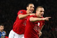 MANCHESTER, UNITED KINGDOM - MARCH 11:  Nemanja Vidic of Manchester United celebrates scoring the opening goal with team mate Rio Ferdinand (L) during the UEFA Champions League Round of Sixteen, Second Leg match between Manchester United and Inter Milan at Old Trafford on March 11, 2009 in Manchester, England.  (Photo by Laurence Griffiths/Getty Images)