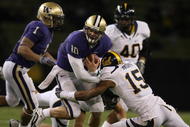 SEATTLE - DECEMBER 05:  Quarterback Jake Locker #10 of the Washington Huskies rushes against Bryant Nnabuife #15 of the California Bears on December 5, 2009 at Husky Stadium in Seattle, Washington. The Huskies defeated the Bears 42-10. (Photo by Otto Greule Jr/Getty Images)