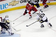 RALEIGH, NC - MAY 26:  Rod Brind'Amour #17 of the Carolina Hurricanes handles the puck against Sidney Crosby #87 and goalie Marc-Andre Fleury #29 of the Pittsburgh Penguins during Game Four of the Eastern Conference Championship Round of the 2009 Stanley Cup Playoffs at RBC Center on May 26, 2009 in Raleigh, North Carolina.   (Photo by Kevin C. Cox/Getty Images)
