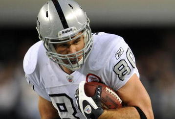 ARLINGTON, TX - NOVEMBER 26:  Tight end Zach Miller #80 of the Oakland Raiders is tackled by Gerald Sensabaugh #43 of the Dallas Cowboys at Cowboys Stadium on November 26, 2009 in Arlington, Texas.  (Photo by Ronald Martinez/Getty Images)