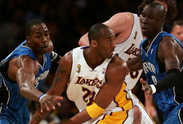 LOS ANGELES, CA - JUNE 07:  Kobe Bryant #24 of the Los Angeles Lakers has the ball as he looks to pass as he is covered by Dwight Howard #12 and Mickael Pietrus #20 of the Orlando Magic in the first quarter of Game Two of the 2009 NBA Finals at Staples Center on June 7, 2009 in Los Angeles, California. NOTE TO USER: User expressly acknowledges and agrees that, by downloading and or using this photograph, User is consenting to the terms and conditions of the Getty Images License Agreement.  (Photo by Jed Jacobsohn/Getty Images)