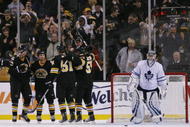 BOSTON - DECEMBER 05:  Marc Savard #91 of the Boston Bruins celebrates his hat trick with teammates Byron Bitz #61 and Johnny Boychuk #55 as Vesa Toskala #35 of the Toronto Maple Leafs looks on December 5, 2009 at the TD Garden in Boston, Massachusetts. The Bruins defeated the Maple Leafs 7-2.  (Photo by Elsa/Getty Images)
