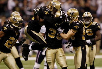 NEW ORLEANS - NOVEMBER 30: Lynell Hamilton #30 of the New Orleans Saints celebrates with teammates after a hit on Matt Slater #18 of the New England Patriots after a kickoff return in the third quarter at Louisana Superdome on November 30, 2009 in New Orleans, Louisiana.  (Photo by Chris Graythen/Getty Images)