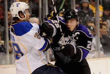 LOS ANGELES, CA - DECEMBER 11:  Dustin Brown #23 of Los Angeles Kings battles with Jeff Woywitka #29 of the St. Louis Blues at the Staples Center on December 11, 2008 in Los Angeles, California.  (Photo by Harry How/Getty Images)