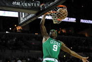 SAN ANTONIO - DECEMBER 03:  Guard Rajon Rondo #9 of the Boston Celtics makes the slam dunk against the San Antonio Spurs on December 3, 2009 at AT&T Center in San Antonio, Texas.  NOTE TO USER: User expressly acknowledges and agrees that, by downloading and/or using this Photograph, user is consenting to the terms and conditions of the Getty Images License Agreement.  (Photo by Ronald Martinez/Getty Images)
