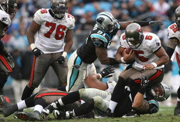 CHARLOTTE, NC - DECEMBER 06:  Josh Freeman #5 of the Tampa Bay Buccaneers is sacked by Everette Brown #91 and the defense of the Carolina Panthers during their game at Bank of America Stadium on December 6, 2009 in Charlotte, North Carolina.  (Photo by Streeter Lecka/Getty Images)