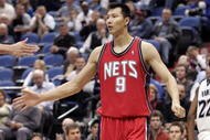 MINNEAPOLIS - OCTOBER 28: Yi Jianlian #9 of the New Jersey Nets is congratulated by a teammate after stopping the Minnesota Timberwolves from scoring at the Target Center on October 28, 2009 in Minneapolis, Minnesota. The Timberwolves defeated the Nets 95-93. NOTE TO USER: User expressly acknowledges and agrees that, by downloading and or using this photograph, User is consenting to the terms and conditions of the Getty Images License Agreement. (Photo by Genevieve Ross/Getty Images)