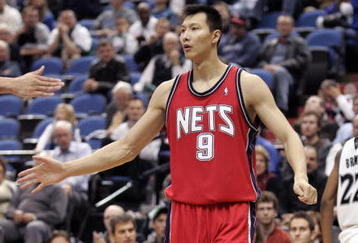 MINNEAPOLIS - OCTOBER 28: Yi Jianlian #9 of the New Jersey Nets is congratulated by a teammate after stopping the Minnesota Timberwolves from scoring at the Target Center on October 28, 2009 in Minneapolis, Minnesota. The Timberwolves defeated the Nets 95-93. NOTE TO USER: User expressly acknowledges and agrees that, by downloading and or using this photograph, User is consenting to the terms and conditions of the Getty Images License Agreement. (Photo by Genevieve Ross/Getty Images)