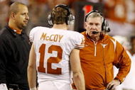 ARLINGTON, TX - DECEMBER 5:  Head coach Mack Brown of the Texas Longhorns speaks to quarterback Colt McCoy #12 during the game against the Nebraska Cornhuskers at Cowboys Stadium on December 5, 2009 in Arlington, Texas. (Photo by Ronald Martinez/Getty Images)