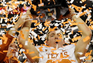 ARLINGTON, TX - DECEMBER 5: Quarterback Colt McCoy #12 of the Texas Longhorns lifts the trophy with head coach Mack Brown after their teams 10-6 victory over the Nebraska Cornhuskers in the game at Cowboys Stadium on December 5, 2009 in Arlington, Texas. (Photo by Ronald Martinez/Getty Images)