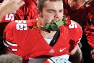 COLUMBUS, OH - NOVEMBER 14:  Offensive lineman George Makridis #56 of the Ohio State Buckeyes celebrates the Buckeyes' 27-24 win over the Iowa Hawkeyes with a rose in his mouth at Ohio Stadium on November 14, 2009 in Columbus, Ohio.  Ohio State will represent the Big Ten Conference in the Rose Bowl.  (Photo by Jamie Sabau/Getty Images)