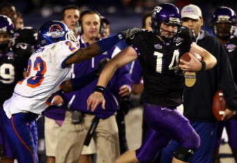 SAN DIEGO, CA - DECEMBER 23:  Quarterback Andy Dalton #14 of  TCU runs with the ball against the tackle of Safety Jeron Johnson #23 of Boise State during the San Diego County Credit Union Poinsettia Bowl at Qualcomm Stadium on December 23, 2008 in San Diego, California. (Photo by Donald Miralle/Getty Images)