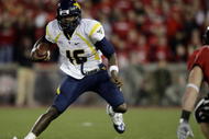 CINCINNATI - NOVEMBER 13:   Quarterback Jarrett Brown #16 of the West Virginia Mountaineers runs with the ball against the Cincinnati Bearcats in the fourth quarter of the game at Nippert Stadium on November 13, 2009 in Cincinnati, Ohio.  (Photo by Andy Lyons/Getty Images)