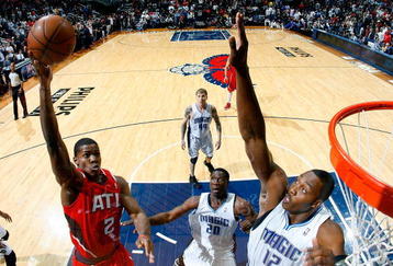 ATLANTA - NOVEMBER 26:  Joe Johnson #2 of the Atlanta Hawks shoots over Dwight Howard #12 of the Orlando Magic at Philips Arena on November 26, 2009 in Atlanta, Georgia.  NOTE TO USER: User expressly acknowledges and agrees that, by downloading and/or using this Photograph, User is consenting to the terms and conditions of the Getty Images License Agreement.  (Photo by Kevin C. Cox/Getty Images)