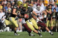 BOULDER, CO - NOVEMBER 07: Quarterback Tyler Hansen #9 of the Colorado Buffaloes rolls out to deliver a pass against the Texas A&M Aggies during NCAA college football action at Folsom Field on November 7, 2009 in Boulder, Colorado. Colorado defeated Texas A&M 35-34. (Photo by Doug Pensinger/Getty Images)