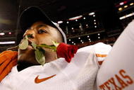 ARLINGTON, TX - DECEMBER 05:  John Chiles #7 of the Texas Longhorns with a rose in his mouth after a win against the Nebraska Cornshuskers at Cowboys Stadium on December 5, 2009 in Arlington, Texas.  (Photo by Ronald Martinez/Getty Images)
