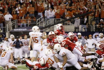 ARLINGTON, TX - DECEMBER 5: Hunter Lawrence #15 of the Texas Longhorns watches the ball after kicking the game-winning field goal to win the game 10-6 over the Nebraska Cornhuskers at Cowboys Stadium on December 5, 2009 in Arlington, Texas.  (Photo by Jamie Squire/Getty Images)