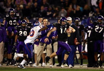 SAN DIEGO, CA - DECEMBER 23:  Quarterback Andy Dalton #14 of  TCU runs with the ball against the tackle of Safety Jeron Johnson #23 of Boise State during the San Diego County Credit Union Poinsettia Bowl at Qualcomm Stadium on December 23, 2008 in San Diego, California. (Photo by Donald Miralle/Getty Images)