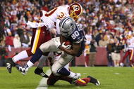 LANDOVER, MD - NOVEMBER 16:  Martellus Bennett #80 of the Dallas Cowboys scores a touchdown in the fourth quarter against LaRon Landry #30 of the Washington Redskins during the game on November 16, 2008 at FedEx Field in Landover, Maryland.  (Photo by Jim McIsaac/Getty Images)
