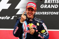 NORTHAMPTON, UNITED KINGDOM - JUNE 21:  Sebastian Vettel of Germany and Red Bull Racing celebrates on the podium after winning the British Formula One Grand Prix at Silverstone on June 21, 2009 in Northampton, England.  (Photo by Clive Mason/Getty Images)