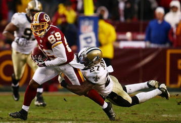 LANDOVER, MD - DECEMBER 06: Santana Moss #89 of the Washington Redskins is tackled by makes a break past Malcolm Jenkins #27 of the New Orleans Saints on December 6, 2009 at FedExField in Landover, Maryland.  (Photo by Chris McGrath/Getty Images)