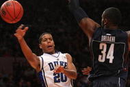 NEW YORK - NOVEMBER 27: Andre Dawkins #20 of the Duke Blue Devils passes around Alex Oriakhi #34 of the Connecticut Huskies during the Championship game at Madison Square Garden on November 27, 2009 in New York, New York. (Photo by Nick Laham/Getty Images)