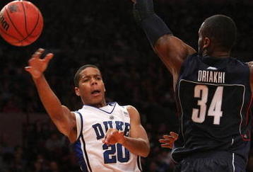 NEW YORK - NOVEMBER 27: Andre Dawkins #20 of the Duke Blue Devils passes around Alex Oriakhi #34 of the Connecticut Huskies during the Championship game at Madison Square Garden on November 27, 2009 in New York, New York.  (Photo by Nick Laham/Getty Images)