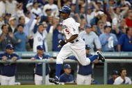 LOS ANGELES, CA - OCTOBER 08:  Juan Pierre #9 of the Los Angeles Dodgers scores the game-tying run in the ninth inning on a single by Ronnie Belliard #3 against the St. Louis Cardinals in Game Two of the NLDS during the 2009 MLB Playoffs at Dodger Stadium on October 8, 2009 in Los Angeles, California. The Dodgers defeated the Cardinals 3-2 to take a 2-0 series lead.  (Photo by Stephen Dunn/Getty Images)