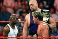 LAS VEGAS - AUGUST 24:  Boxer Floyd Mayweather Jr. (L) stares down wrestlers Chris Jericho and Big Show during the WWE Monday Night Raw show at the Thomas & Mack Center August 24, 2009 in Las Vegas, Nevada. Mayweather was a special guest host during the broadcast.  (Photo by Ethan Miller/Getty Images)