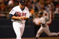 MINNEAPOLIS - OCTOBER 11: Carl Pavano #48 of the Minnesota Twins reacts as Jorge Posada #20 of the New York Yankees runs the bases after hitting a solo home run in the 7th inning in Game Three of the ALDS during the 2009 MLB Playoffs at the Hubert H. Humphrey Metrodome on October 11, 2009 in Minneapolis, Minnesota. (Photo by Jonathan Daniel/Getty Images)