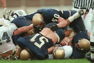 2 Nov 1996:  A number of Navy defenders make a tackle during a 54-27 Shamrock Classic loss to the University of Notre Dame in Dublin, Ireland. Mandatory Credit: Billy Stickland/ALLSPORT