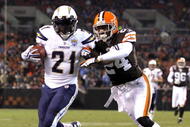 CLEVELAND - DECEMBER 06:  LaDainian Tomlinson #21 of the San Diego Chargers is hit by Eric Wright #24 of the Cleveland Browns at Cleveland Browns Stadium on December 6, 2009 in Cleveland, Ohio.  (Photo by Matt Sullivan/Getty Images)