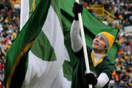 GREEN BAY, WI - NOVEMBER 16:  A Green Bay Packers cheerleader waves a flag in support of his team against the Chicago Bears during NFL action at Lambeau Field on November 16, 2008 in Green Bay, Wisconsin. The Packers defeated the Bears 37-3.  (Photo by Doug Pensinger/Getty Images)