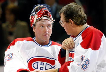 MONTREAL- DECEMBER 4:  Former Montreal Canadiens Serge Savard hands a puck to Patrick Roy during the Centennial Celebration ceremonies prior to the NHL game between the Montreal Canadiens and Boston Bruins on December 4, 2009 at the Bell Centre in Montreal, Quebec, Canada.  The Canadiens defeated the Bruins 5-1.  (Photo by Richard Wolowicz/Getty Images)